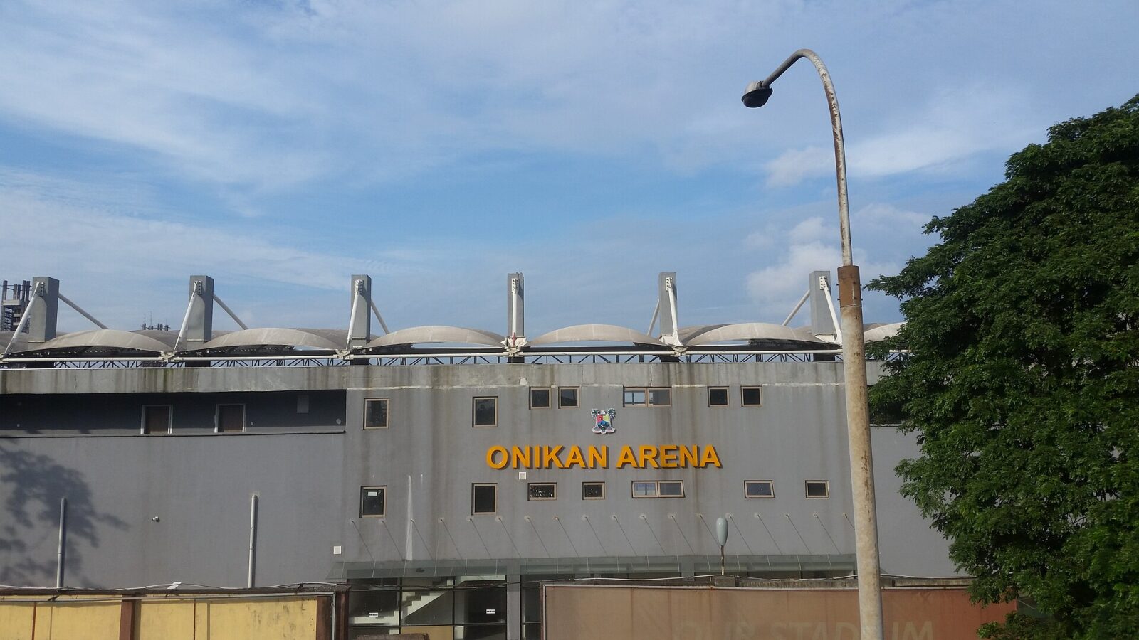 Back exterior view of Onikan Arena (Mobolaji Johnson Arena) in Lagos showing the stadium facade and surroundings