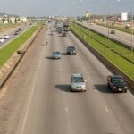 Kubwa Expressway road with vehicles and nearby buildings in Kubwa, Abuja