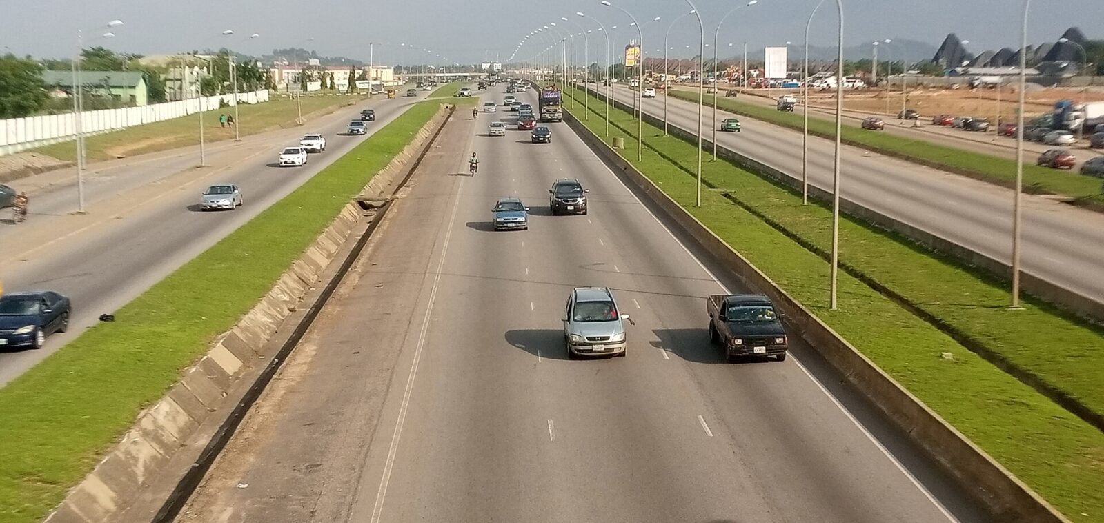 Kubwa Expressway road with vehicles and nearby buildings in Kubwa, Abuja