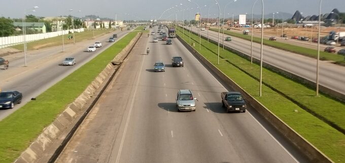 Kubwa Expressway road with vehicles and nearby buildings in Kubwa, Abuja