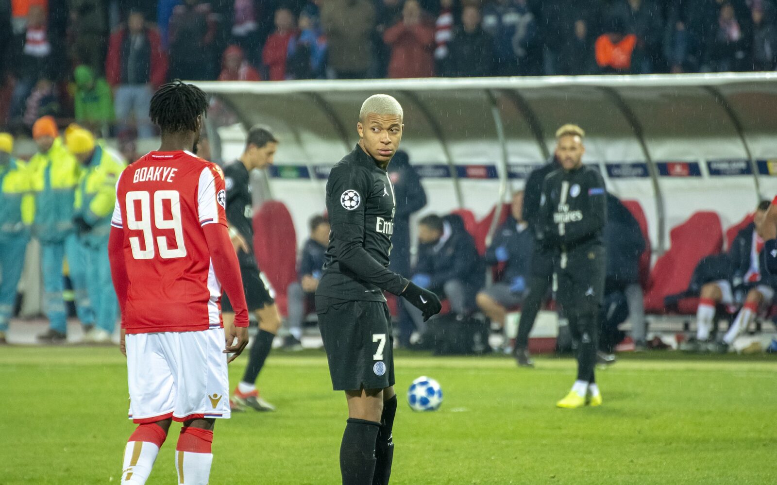 Kylian Mbappé standing on a football pitch