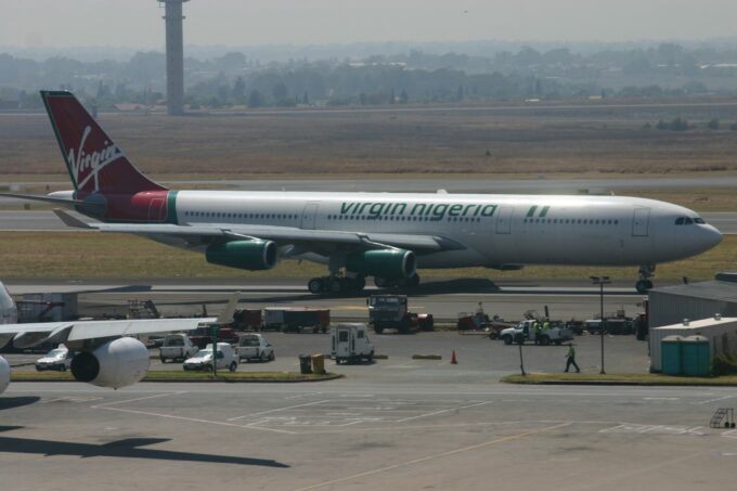 Virgin Nigeria Airbus A340 parked at Johannesburg O.R. Tambo International Airport terminal