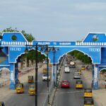 Maiduguri city gate with palm trees and road in Borno State, Nigeria