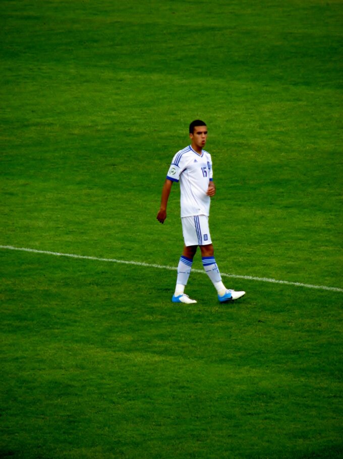 Dimitris Kourbelis wearing Greece kit controlling the ball during an international match