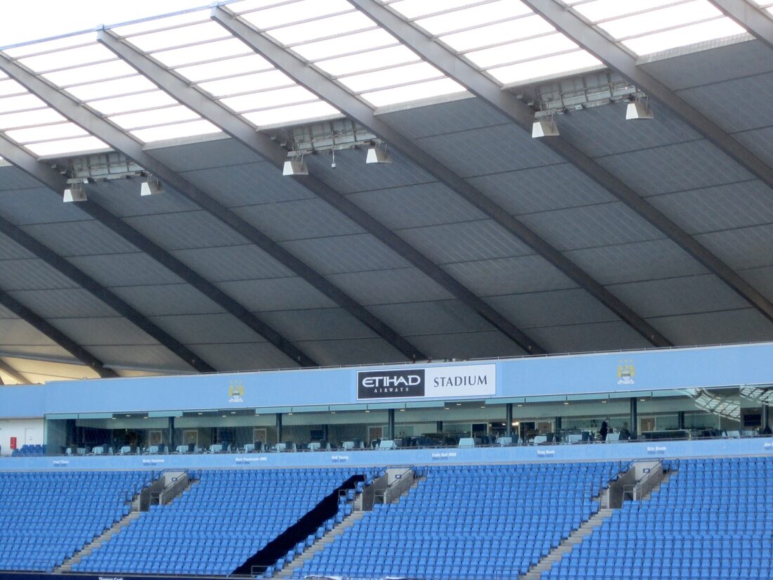 Exterior view of the Etihad Stadium, Manchester City's home ground, showing stands and floodlights
